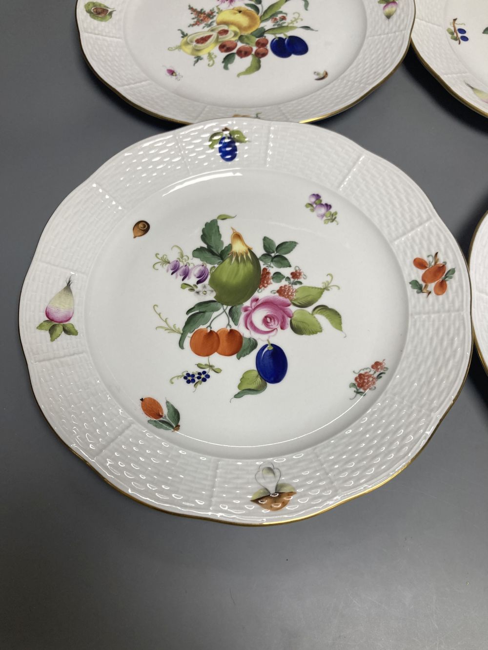 A set of four Herend Meissen style floral painted dessert dishes, diameter 25.5cm